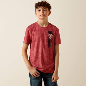 Young boy wearing a red t-shirt with a graphic design on a beige background