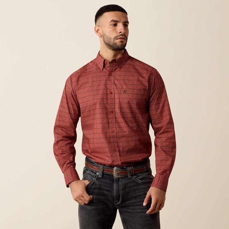 A man wearing a long-sleeve button-down shirt with a red and black geometric pattern