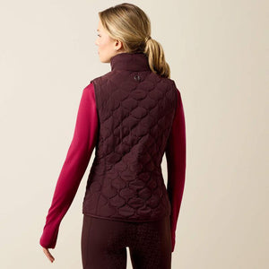 A woman modeling a dark plum quilted zip-front vest 