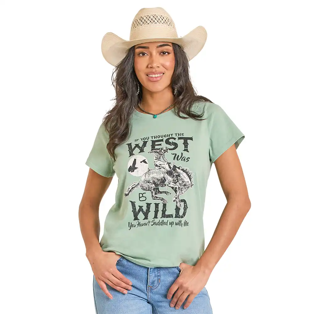 Woman wearing a light green t-shirt with a graphic design and text,