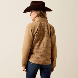 A woman wearing a tan western-style zip-front jacket with a brown horse-print pattern. 