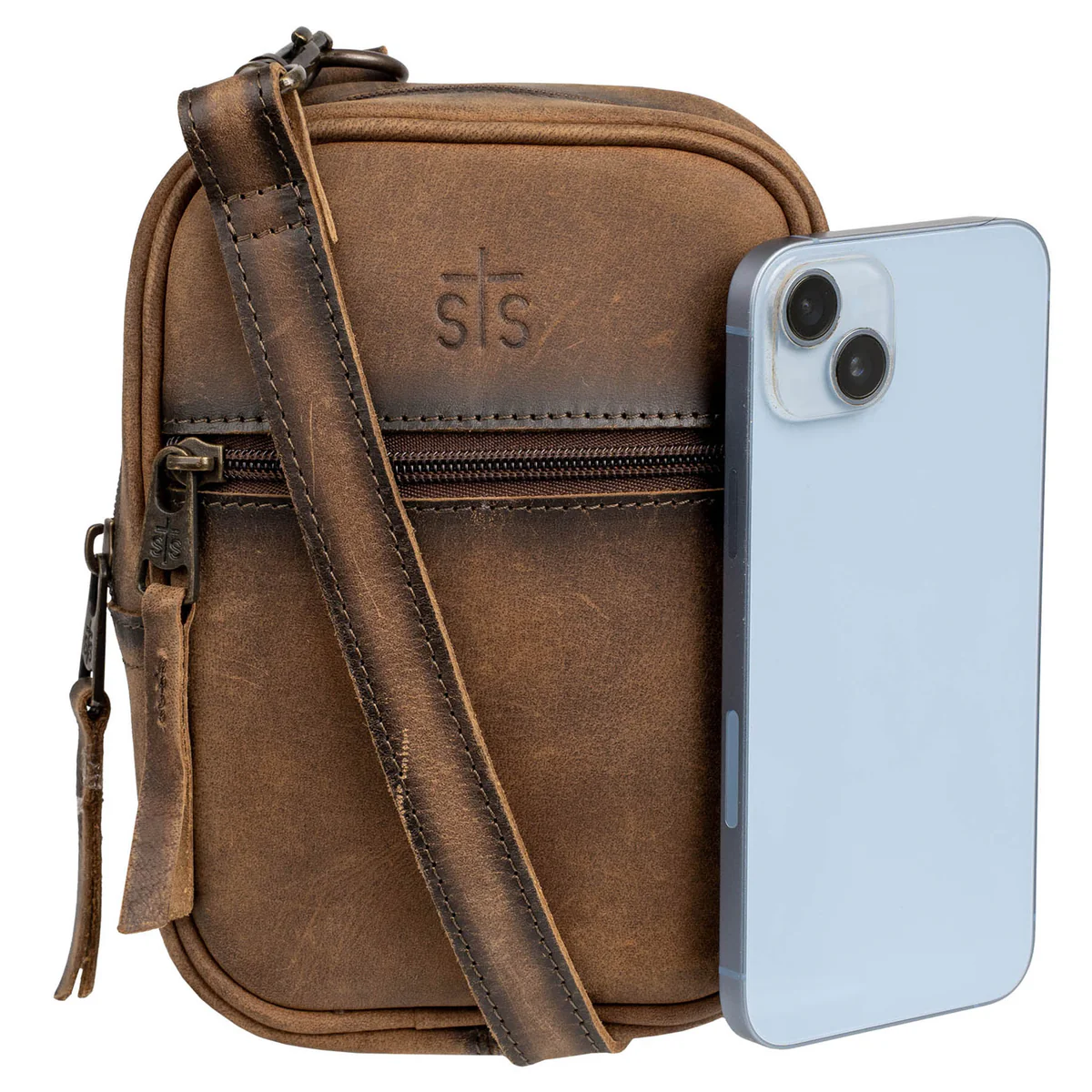 Brown leather crossbody bag with a phone on a white background