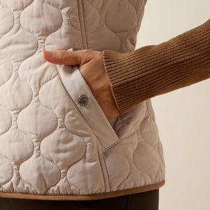 A woman modeling a quilted sleeveless vest 