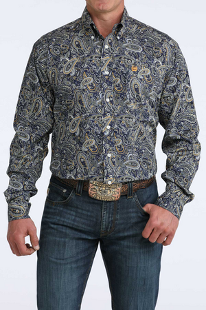 Man wearing a patterned shirt and jeans on a white background