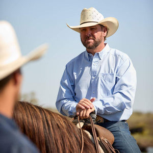 Man wearing a light blue button-up shirt