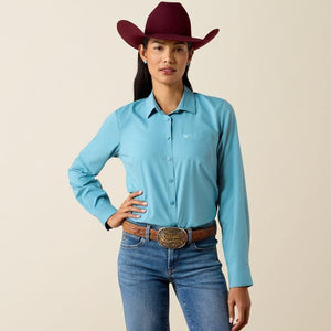 A woman modeling a light blue long-sleeve western button-up shirt  