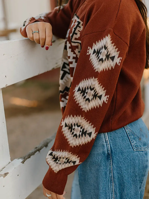 Woman wearing an Aztec patterned sweater