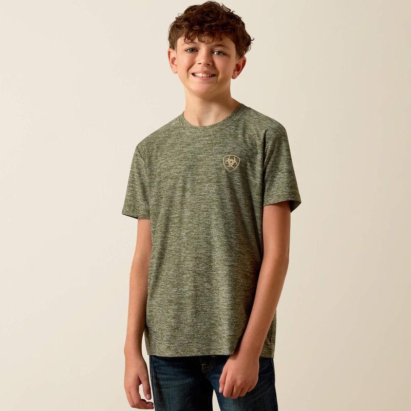 Young boy wearing a green t-shirt with a logo on a beige background
