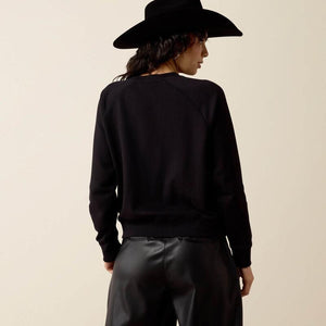 A model shown from the back wearing a black crewneck sweatshirt. 