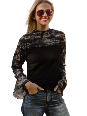 Woman wearing a black western patterned shirt