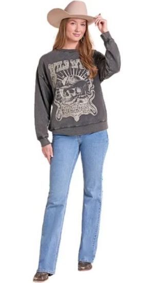A woman modeling a dark gray graphic sweatshirt with a skull design, paired with light blue jeans and a beige cowboy hat, against a plain white background.
