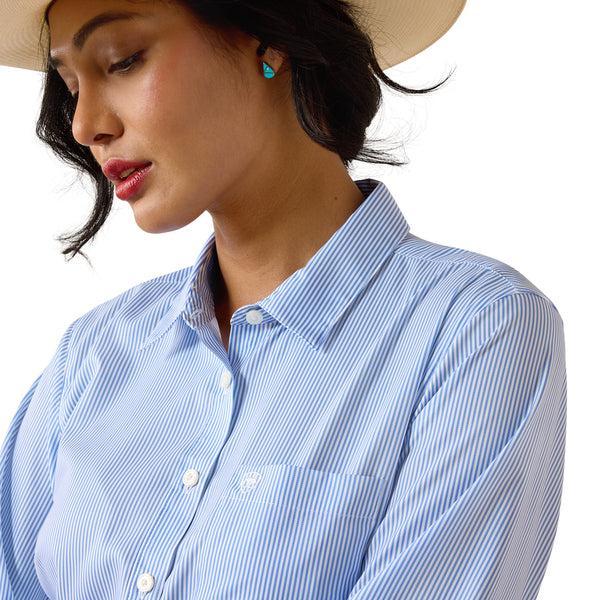 Woman wearing a blue striped shirt and beige hat on a white background