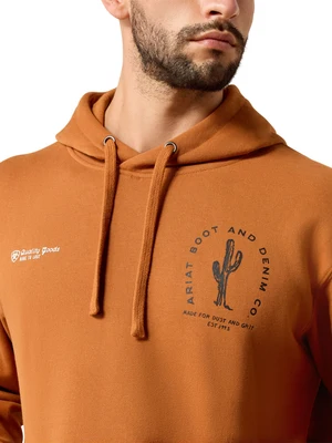 A close-up of a man wearing a burnt orange hoodie with a black cactus graphic and 'Ariat Boot and Denim Co' text on the chest, and a small white 'Quality Goods' logo on the sleeve.
