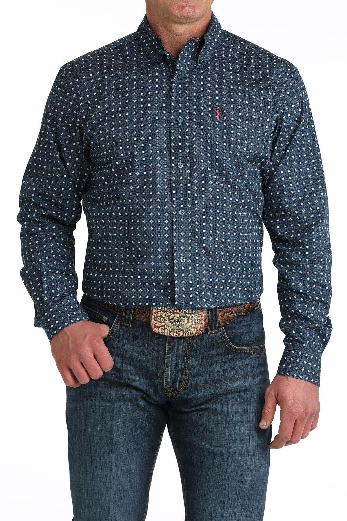 Man wearing a blue patterned shirt and jeans on a white background
