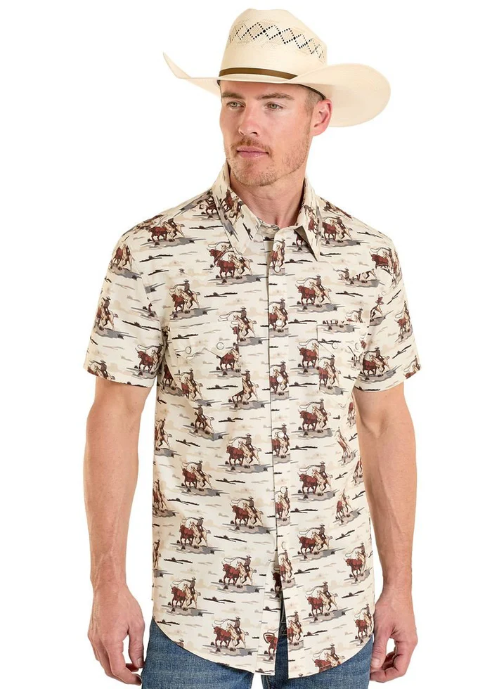 Man wearing a cream-colored short-sleeve shirt with cowboy pattern and a beige cowboy hat on a white background