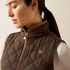 A woman modeling a brown quilted zip-front vest 