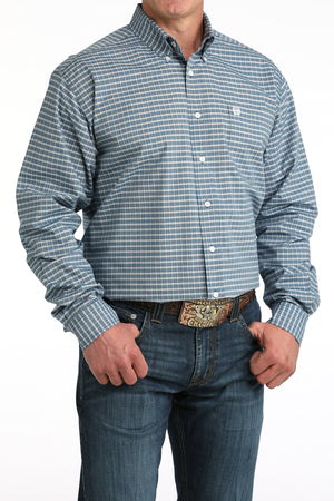 Man wearing a blue checkered shirt and jeans on a white background