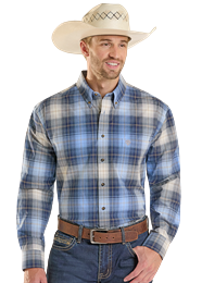 Man wearing a plaid shirt and cowboy hat in an outdoor setting