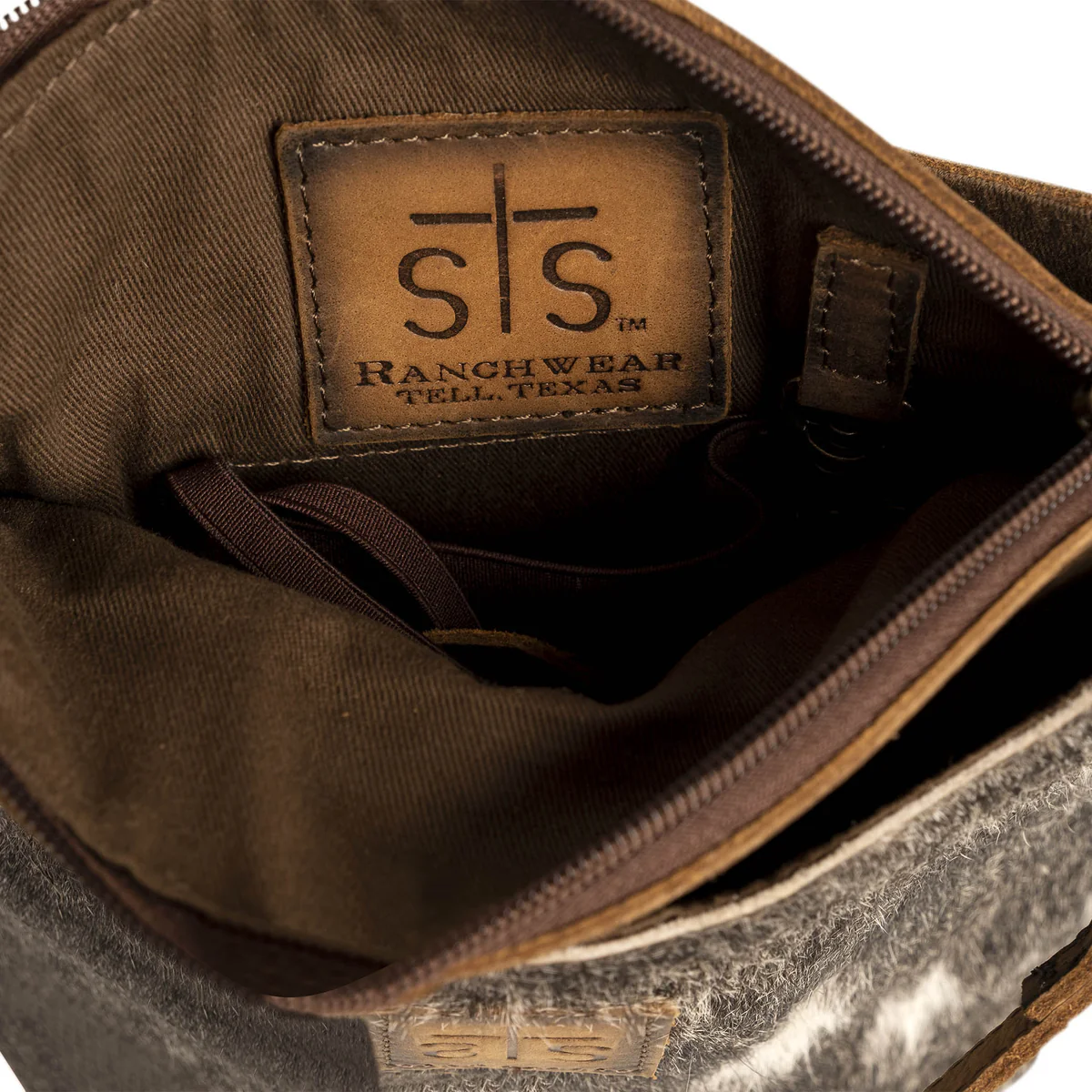 Close-up of a brown leather bag with 'sts Ranchwear' logo.