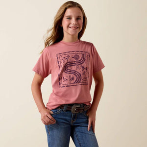 Young girl wearing a pink t-shirt with a graphic design on a beige background