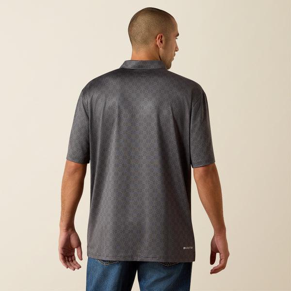 Man wearing a gray patterned polo shirt against a beige background