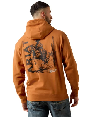 A man wearing an orange-brown hoodie from the back, showing a large black graphic print with the word 'ARIAT' and a cowboy riding a horse, paired with blue jeans against a white background.