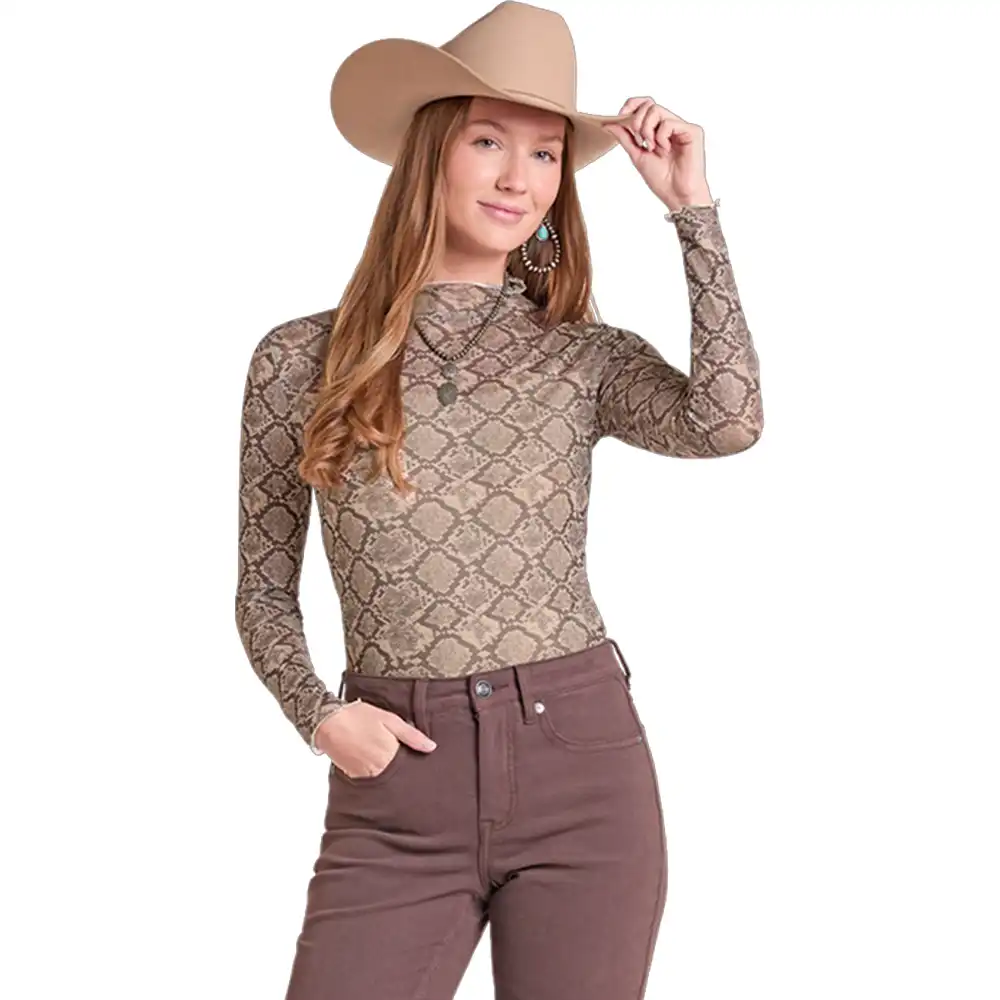 A woman modeling a fitted long-sleeve mock neck top with a brown and beige snakeskin pattern, paired with brown pants and a tan cowboy hat, against a plain white background.