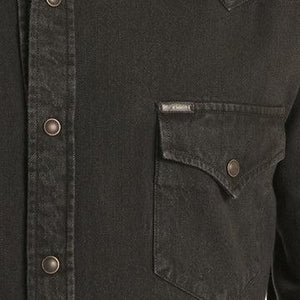 A man wearing a black western long-sleeve snap-down shirt 