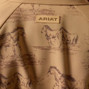 A woman wearing a tan western-style zip-front jacket with a brown horse-print pattern. 