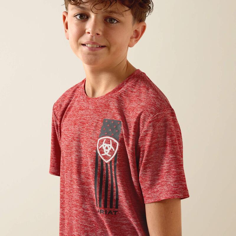 Child wearing a red t-shirt with a logo on a beige background