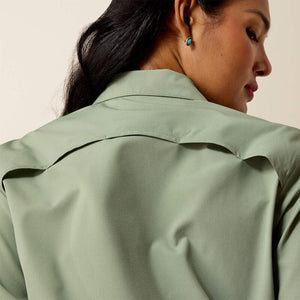 Woman wearing a light green shirt with a neutral background