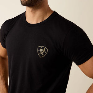 Man wearing a black t-shirt with 'Ariat Int.' logo on the back 
