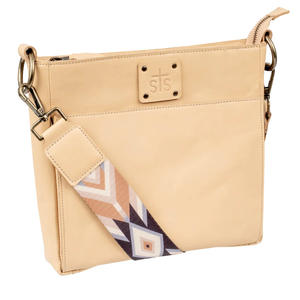 Beige handbag with a patterned strap on a white background