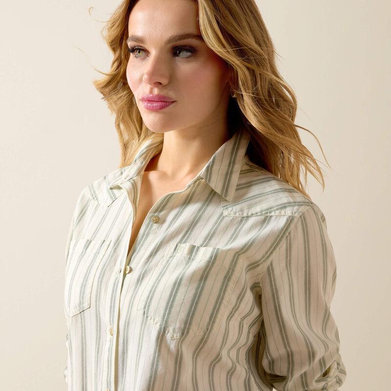 Woman wearing a striped shirt against a plain background