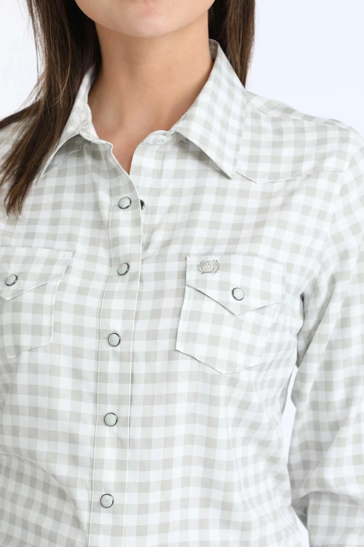Close-up of a person wearing a light gray and white checkered shirt.