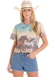 Woman wearing a t-shirt with horse graphics and a cowboy hat.