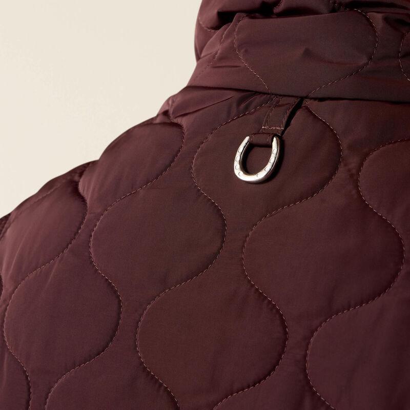 A woman modeling a dark plum quilted zip-front vest 