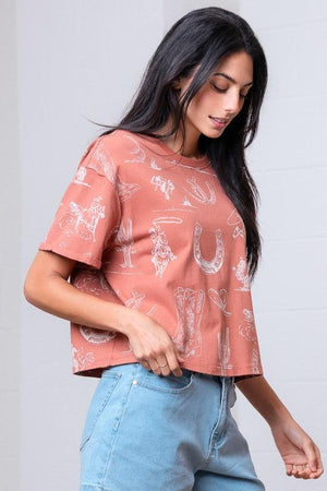 Woman wearing a patterned rust shirt