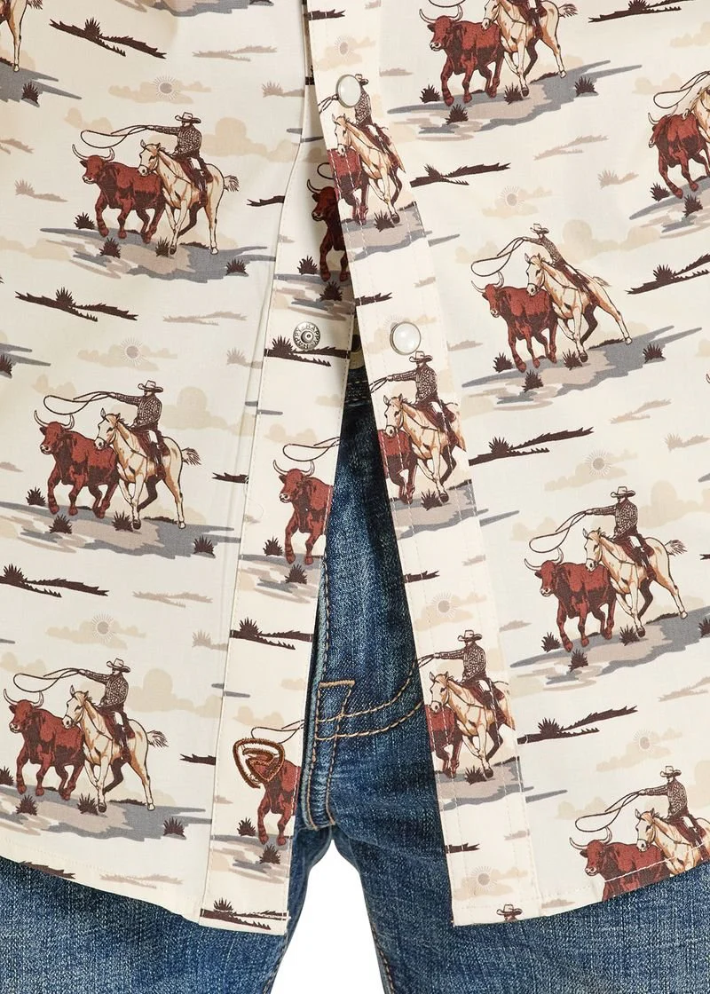 Close-up of a shirt with cowboy pattern and jeans, featuring images of cowboys on horses and cattle.