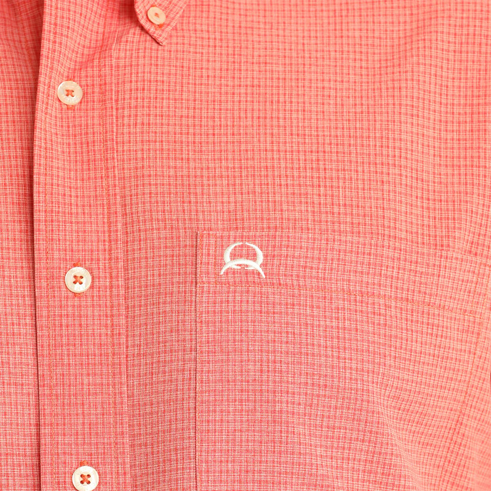 Man wearing a red short-sleeve shirt and blue jeans on a white background