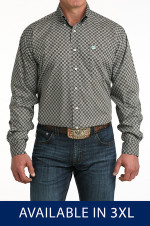 Man wearing a patterned shirt and jeans with a belt buckle, on a white background.