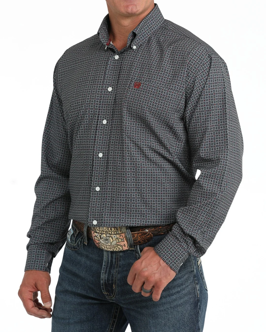 A man wearing a blue and burgundy micro-patterned western long-sleeve button-down shirt with a small red embroidered logo on the chest 