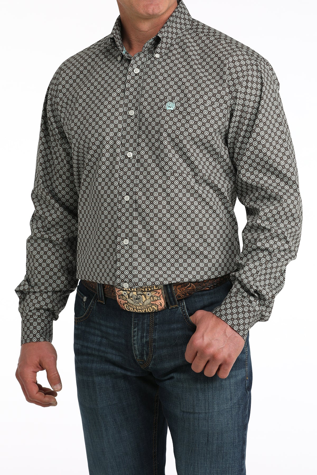 Man wearing a patterned long-sleeve shirt and jeans on a white background