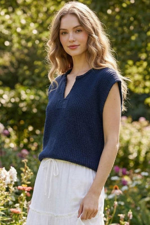 Woman wearing a blue sleeveless knitted top 