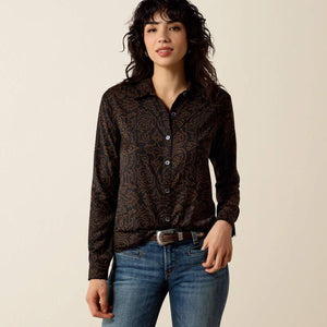 A woman modeling a long-sleeve button-up shirt with a dark brown and black paisley pattern. 