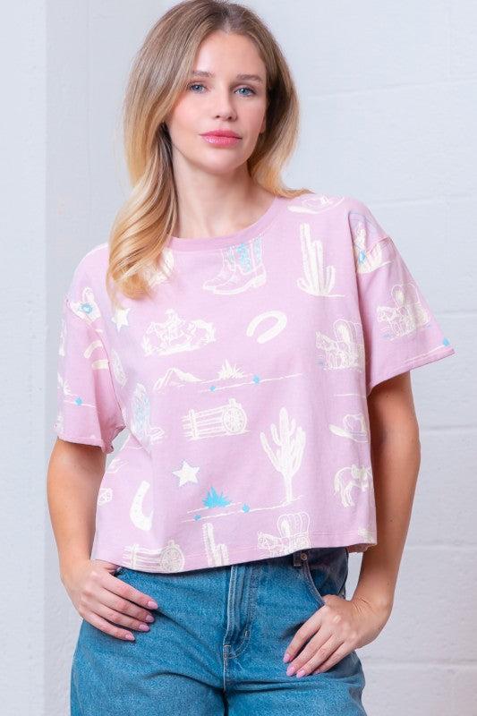 Woman wearing a pink t-shirt with white graphics