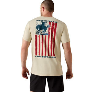 Man wearing a beige t-shirt with an American flag and horse graphic, brand 'Ariat' visible.