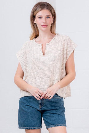 Woman wearing a beige textured top 