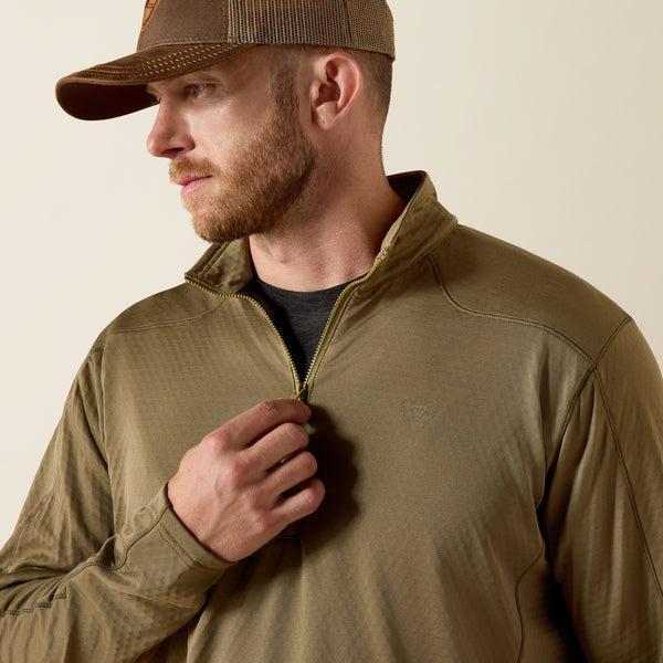 Man wearing a dusky green quarter-zip pullover