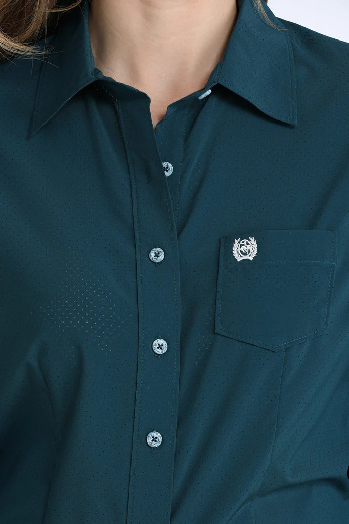 Close-up of a dark green shirt with a collar and button details.